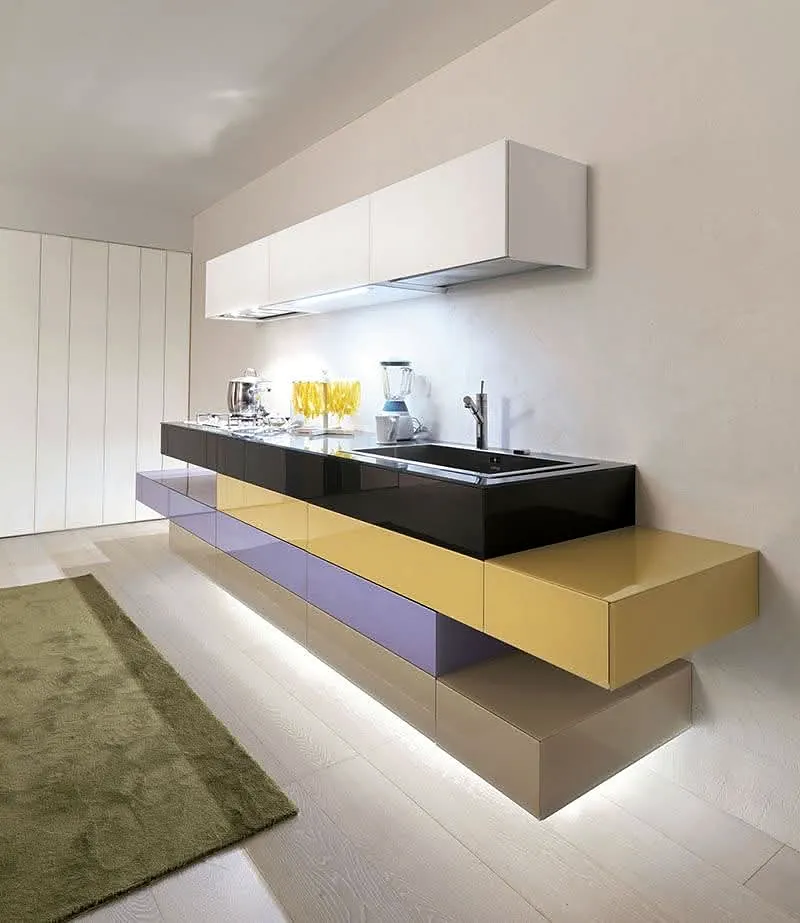 Wall-mounted kitchen cabinetry in mustard and plum with a black sink and worktop, white wall cabinets and lighting below