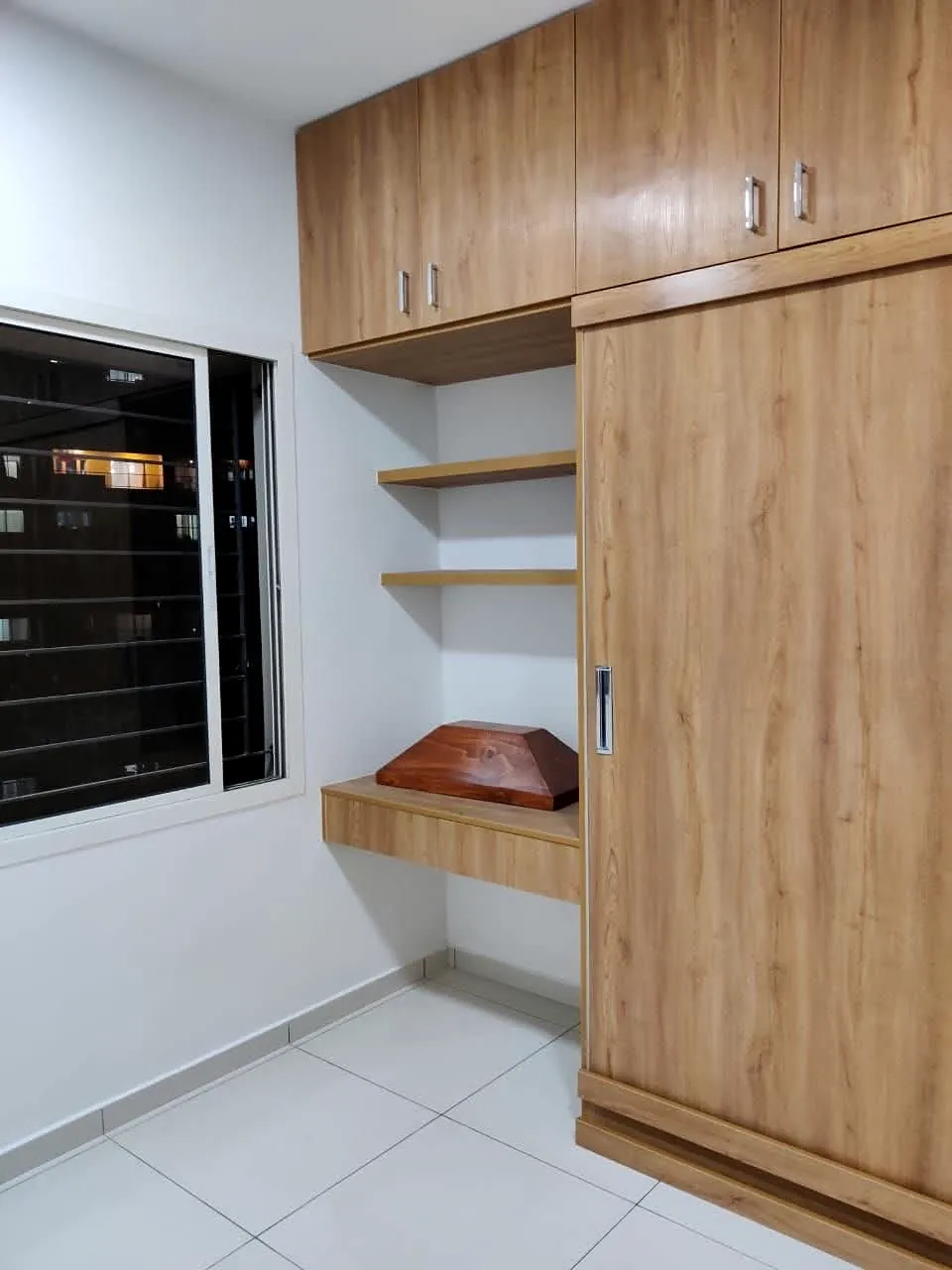 Wood-finish bedroom wardrobe with overhead cabinets, open shelves and a compact desk