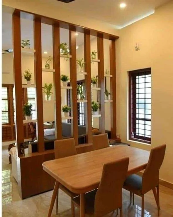 Photographed Mumbai dining space with timber screen, pendant light and warm built-in details